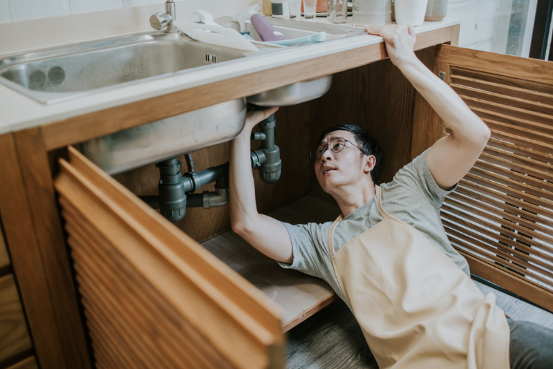 Handsome Asian Plumber Repair Water Pipe